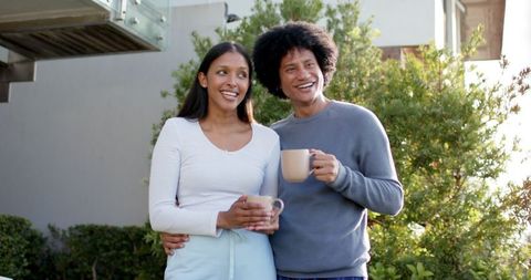 Smiling couple enjoying time together on sunlit garden patio