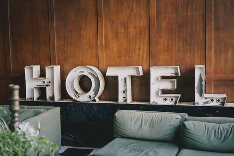 Rustic hotel sign adds vintage charm to cozy interior