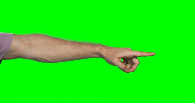 A Caucasian male's arm is extended with a pointing gesture against a green screen background, with copy space. Pointing gestures can indicate direction, emphasize an object or idea, or be part of a communication in sign language.