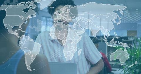 Man typing on laptop with world map overlay for global analytics and collaboration