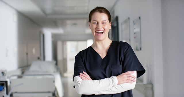 Confident Nurse Wearing Scrubs Standing in Hospital Hallway - Download Free Stock Images Pikwizard.com