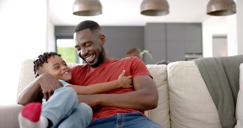 Father and Son Bonding in Cozy Living Room with Joyful Expressions
