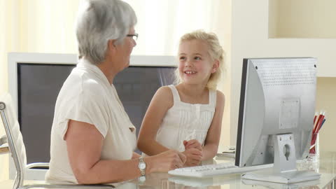 Granddaughter Helping Grandmother with Computer Learning