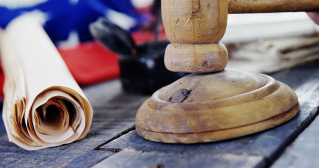 A wooden gavel lies on a table next to legal documents, symbolizing law and justice, with copy space. Its presence suggests a legal setting, a courtroom or lawyer's office.