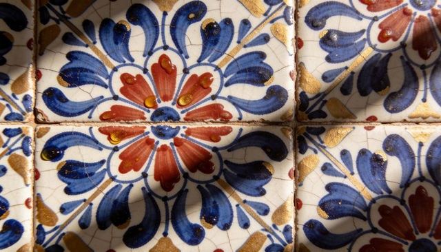 Handcrafted talavera ceramic tile panel with blue floral medallions and gold leaf accents