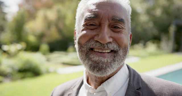 Smiling Elderly Man Relaxing Outdoors on Sunny Day - Download Free Stock Images Pikwizard.com