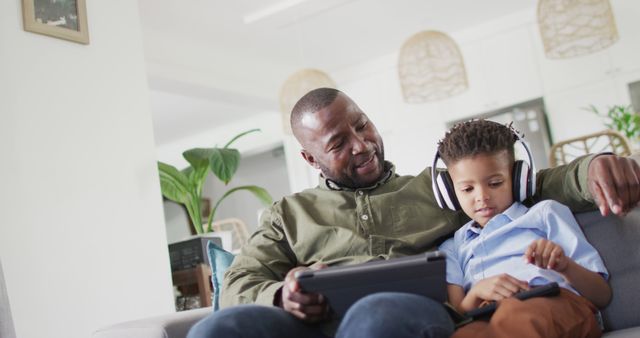 Father and Son Bonding at Home with Tablet and Headphones - Download Free Stock Images Pikwizard.com