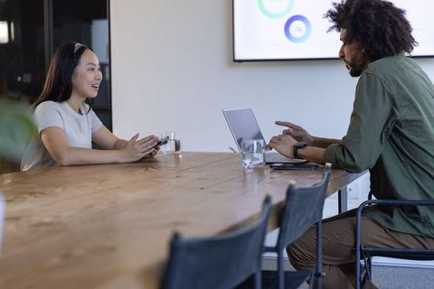 Diverse professionals collaborating with digital devices in modern office