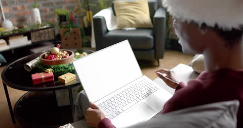Man Using Laptop for Christmas Video Call at Home