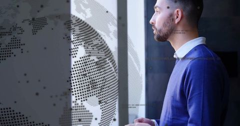 Business professional gazing contemplatively at world map digital overlay