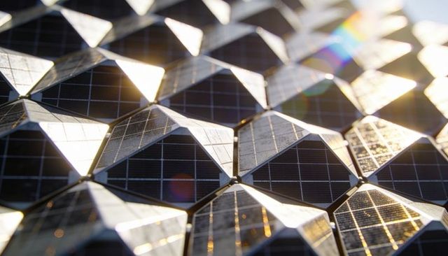 Faceted solar tile array reflecting sunlight with prismatic lens flare and glossy bevels