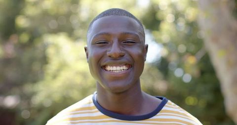 Smiling Young African American enjoying Sunny Garden Outdoors