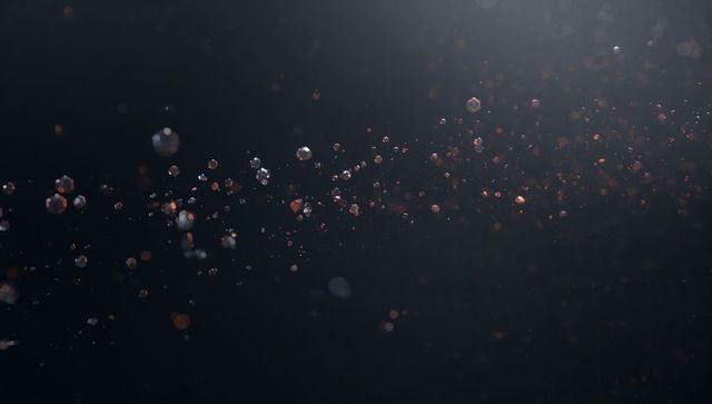 Shimmering Dust and Bokeh Particles Floating Diagonal Band on Dark Background
