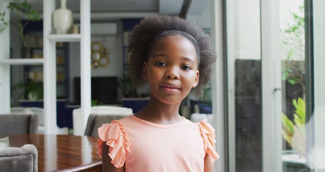 Image of portrait of african american girl. Enjoying quality family time together at home.