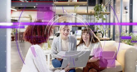 Team collaborating around laptop in modern coworking lounge for creative projects with HUD overlay