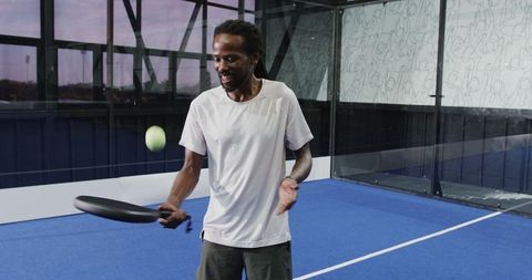 Man Practicing Padel Tennis Skill on Indoor Court