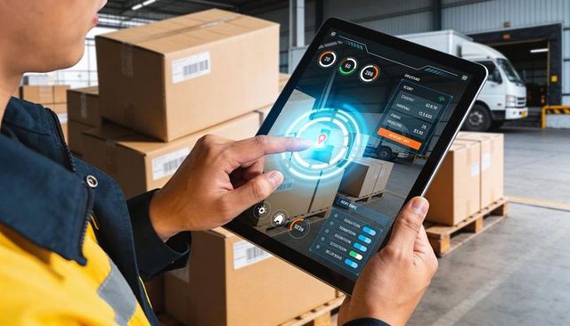 Warehouse worker using tablet for real-time inventory tracking with ar dashboard overlay