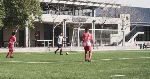 Youth Soccer Players Engaging in Lively Indoor Game on School Field
