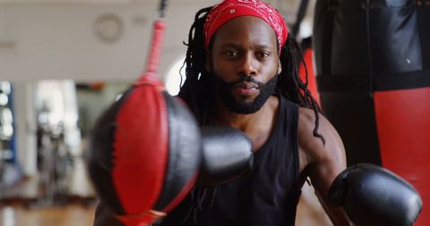 Young Male Boxer Practicing Punches in Fitness Studio