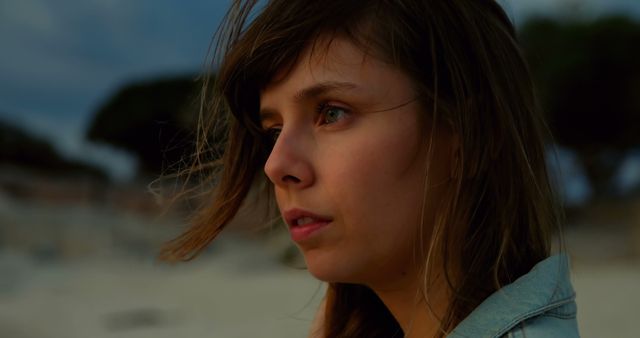 Pensive Young Woman Contemplating Outdoors at Dusk - Download Free Stock Images Pikwizard.com