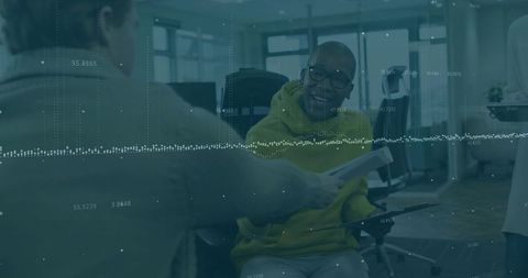 Smiling colleague receiving document in open-plan office with digital analytics overlay