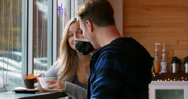 Young romantic couple interacting with each other in cafe. Couple having coffee in cafe 4k