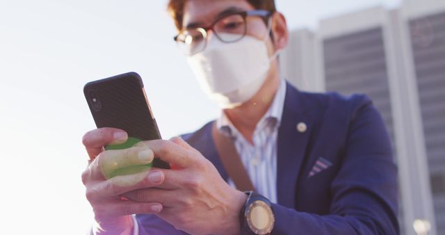 Businessman Wearing Mask Checking Phone Outdoors - Download Free Stock Images Pikwizard.com