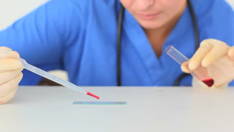 Female Scientist Preparing Microscope Slide in Laboratory