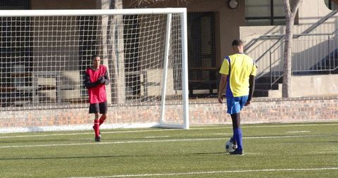 Youth Soccer Players Preparing for Penalty Kick at School Field