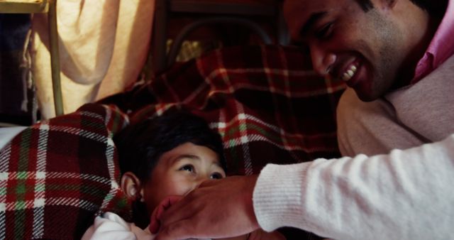 Father Bonding with Smiling Toddler in Cozy Blanket Setting - Download Free Stock Images Pikwizard.com