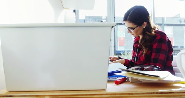 Young Woman Studying at Desk in Sunlit Room - Download Free Stock Images Pikwizard.com