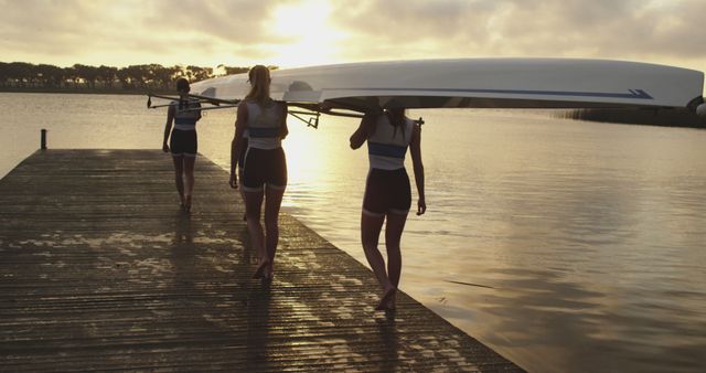 Female Rowing Team Carrying Boat at Sunrise on Pier - Download Free Stock Images Pikwizard.com