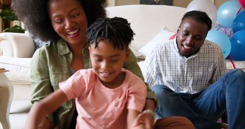 Happy Family Celebrating with Child in Party Atmosphere