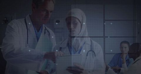 Multicultural medical team collaborating on digital tablet with clinical dashboard overlay