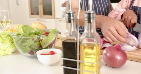 Senior Couple Preparing Salad in Cozy Modern Kitchen