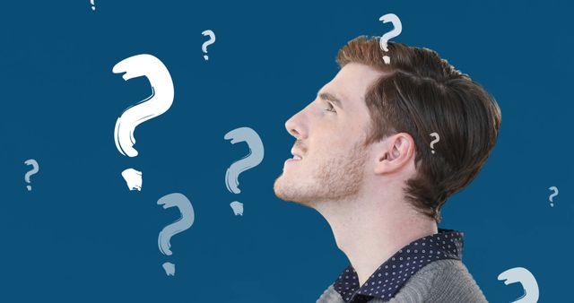 Man looking up at floating question marks, conveying a sense of curiosity and contemplation. Ideal for content about problem-solving, brainstorming, decision-making, or illustrating uncertainty.