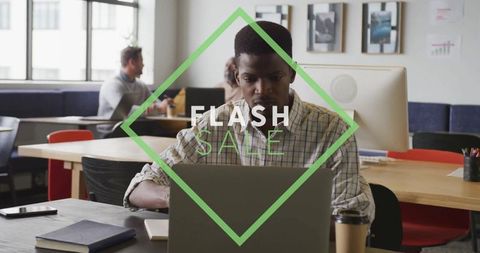 Focused Business Professional Typing on Laptop with Flash Sale Overlay