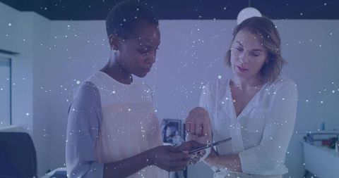 Businesswomen Collaborating with Smartphone and Futuristic Network