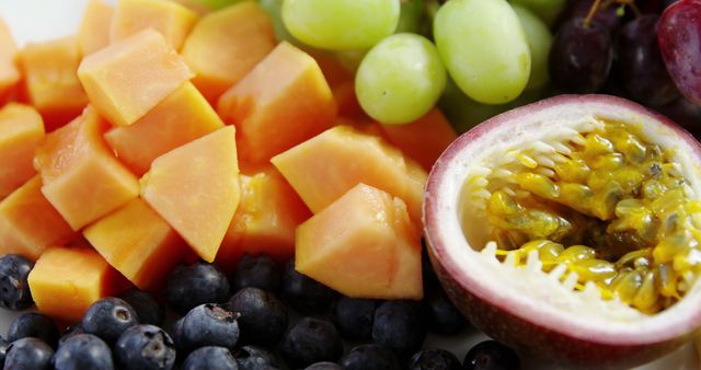 Fresh Mixed Fruits Including Papaya, Grapes, Blueberries, and Passion Fruit Cut in Half - Download Free Stock Images Pikwizard.com