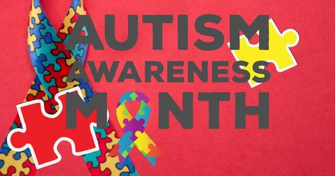 Autism awareness month puzzle ribbon on red background