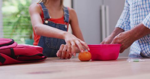 Grandfather and granddaughter preparing lunch together