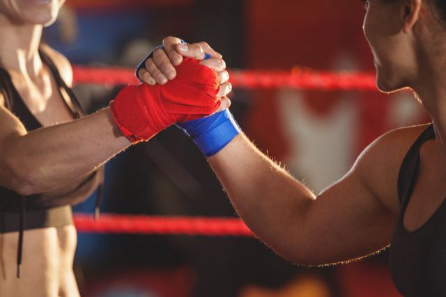 Two female boxers greeting each other in the ring at fitness studio