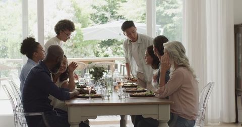 Diverse Group Enjoying Lunch, Celebrating Togetherness at Home