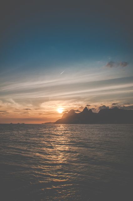 Serene Ocean Sunset with Coastal Mountains - Download Free Stock Photos Pikwizard.com