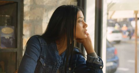 Thoughtful Woman Looking Out Window in Denim Jacket - Download Free Stock Images Pikwizard.com