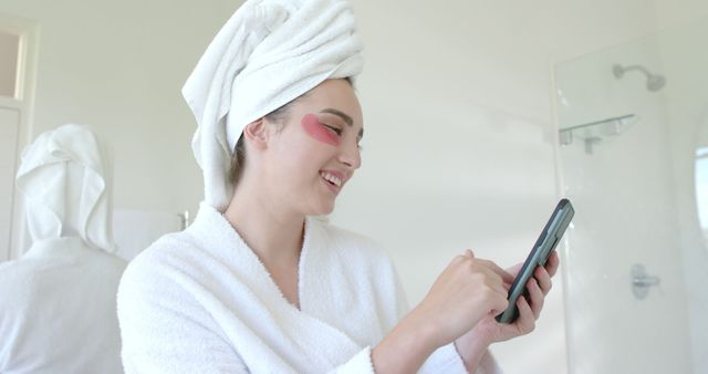 Woman with Towel on Head Using Smartphone in Bathroom - Download Free Stock Images Pikwizard.com