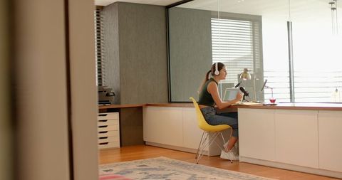Woman Podcasting in Modern Home Office with Headphones