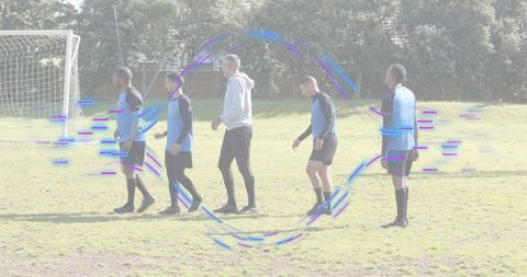 Youth soccer team walking warmup drill with coach on grass field, glitch overlay