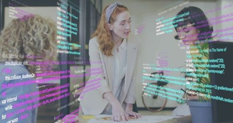 Redhead project lead pointing at diagrams in team tech workshop with code overlay