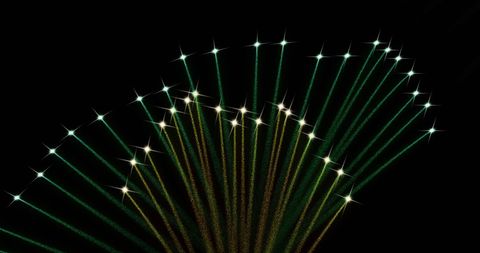 Stellar Green and Yellow Fireworks Exploding Against Night Sky